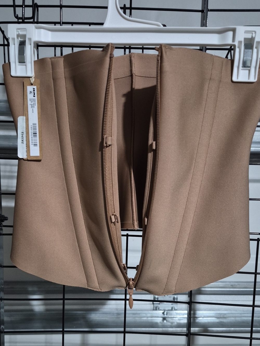 SKIMS corset-style waist top/bustier in a taupe/beige color.